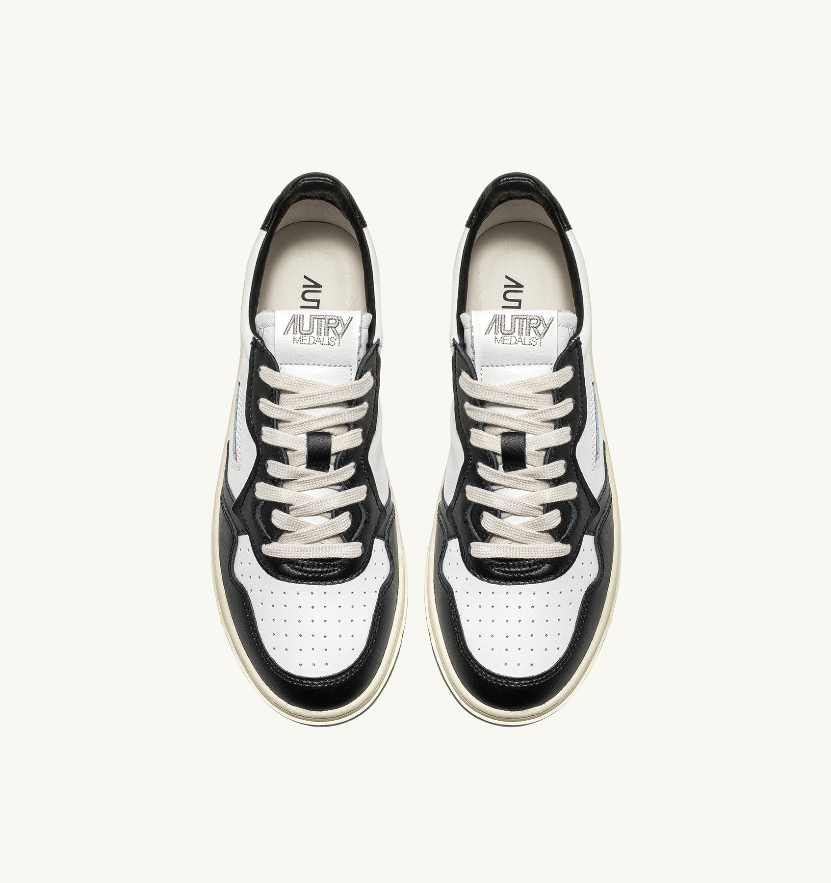 AUTRY - MEDALIST LOW BICOLOR SNEAKERS IN WHITE AND BLACK LEATHER (Women) - ASTOREHERE